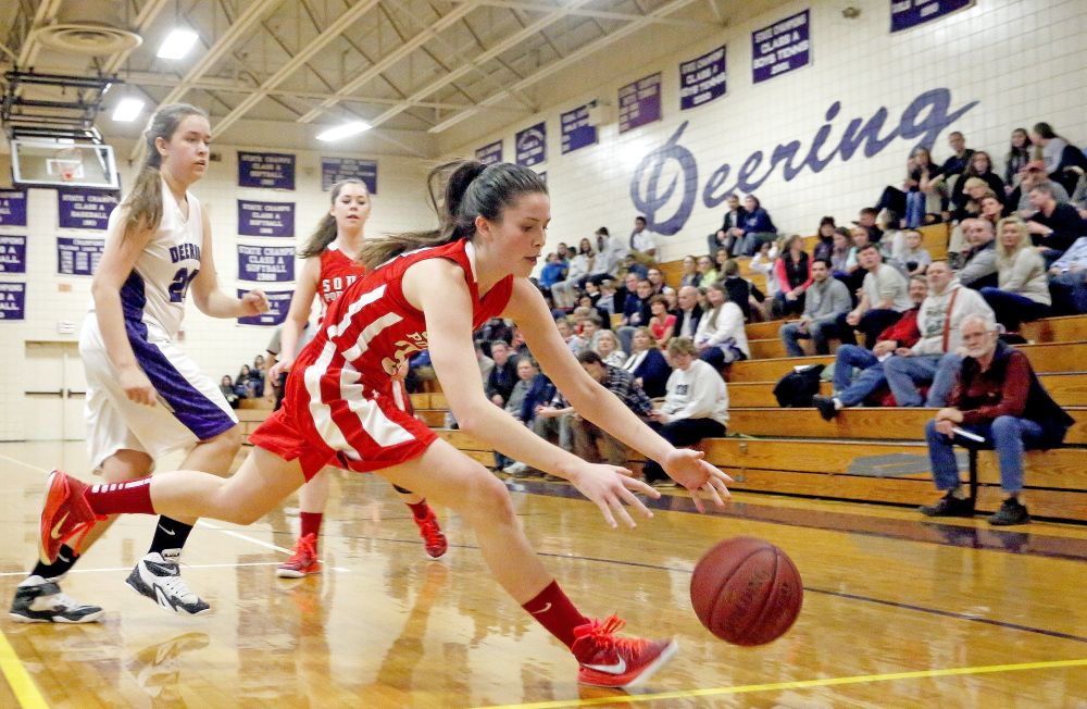 South Portland's Maddie Hasson tries to rescue the ball before it goes out of bounds as Deering's Katie Howard, background, looks on,  during a girls basketball game at Deering on Tuesday.
