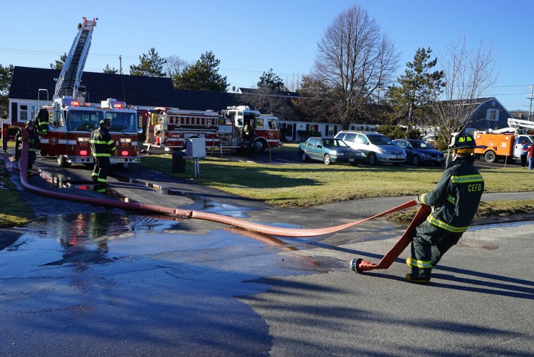 Firefighters work at the scene of a fatal fire on Starboard Drive in Cape Elizabeth on Friday.