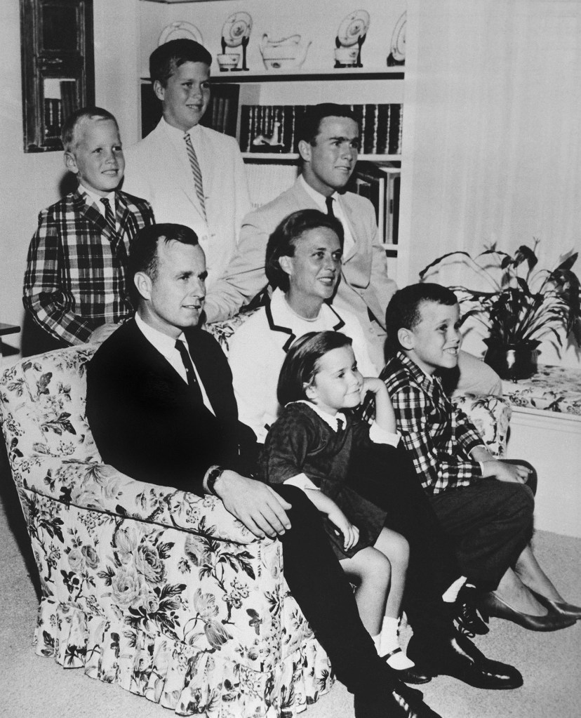 In this 1964 file photo, George H.W. Bush sits on couch with his wife Barbara and their children. George W. Bush sits at right behind his mother. Behind the couch are Neil and Jeb Bush. Sitting with parents are Dorothy and Marvin Bush.