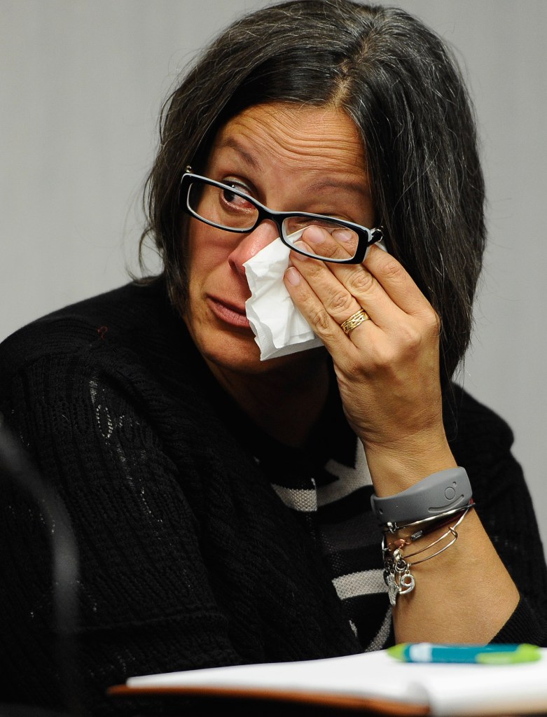 Kathleen Flaherty, a member of the Sandy Hook Advisory Commission, wipes her eye during a presentation last month by two families who lost children in the Sandy Hook Elementary School shooting in Newtown, Conn. The parents made presentations on ways to better address mental health, school safety and gun violence prevention.