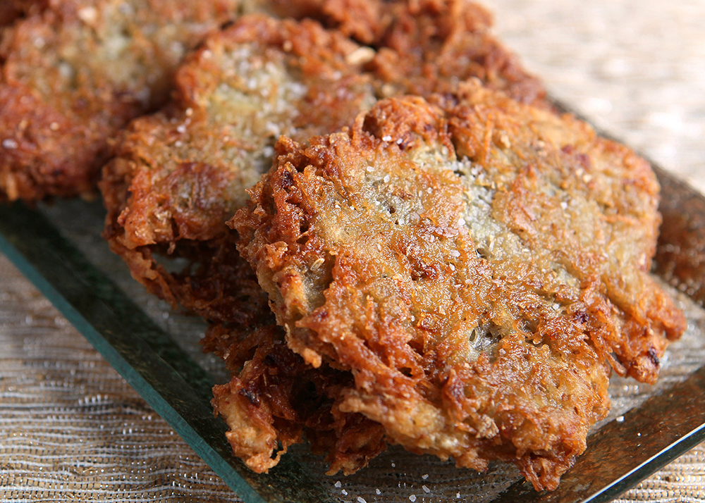 Latkes, also commonly called potato pancakes, are prepared by frying grated potato and onions.