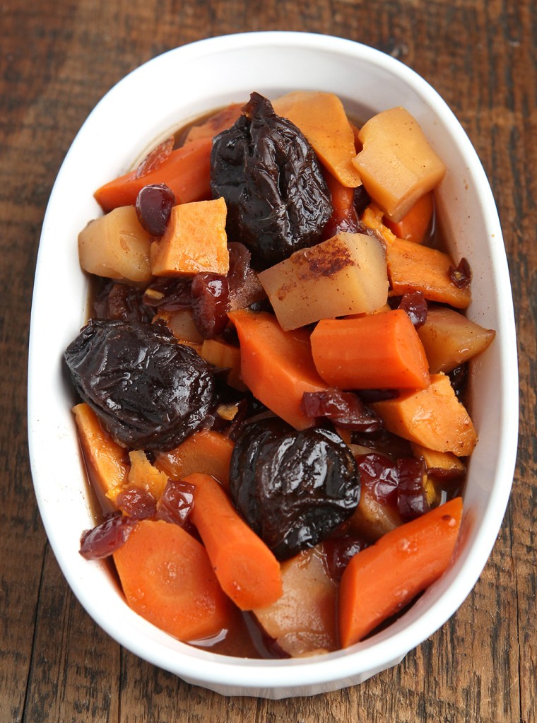 Tzimmes prepared with carrots, sweet potatoes, parsnips, prunes, cranberries and cinnamon.