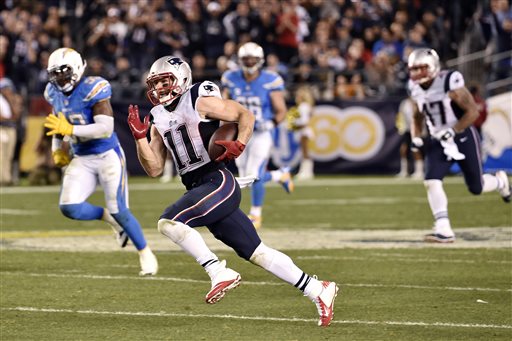 Patriots wide receiver Julian Edelman runs for a touchdown against San Diego on Sunday. The Associated Press