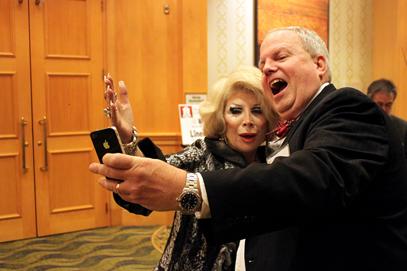 Linda Axelrod (as Joan Rivers) and a fan take a selfie before an event. The celebrity impersonator's business has not slowed down since Rivers' death. Washington Post photo by Jessica Contrera