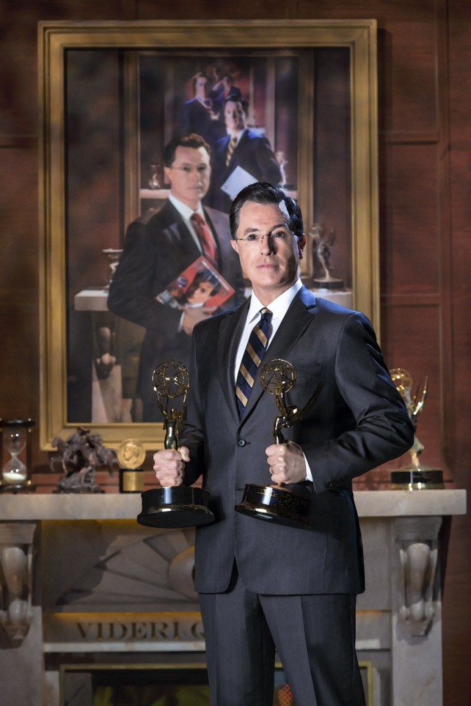 Stephen Colbert poses in front of his portrait in this photo provided by the Smithsonian. The portrait will be installed Friday and be displayed through April 19, once again between the bathrooms and above a water fountain. The Associated Press