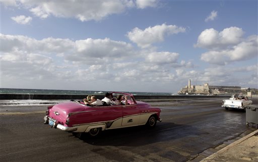 Tourists ride in classic cars along Havana's Malecon in this April 7, 2009, photo. The Associated Press