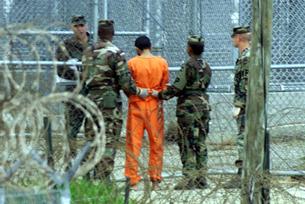 Military police on the Naval Base at Guantanamo Bay bring a detainee back to his cell after an interrogation session in this Feb. 6, 2002, photo. The methods used to interrogate detainees "regularly resulted in fabricated information," the Senate report concludes. Reuters