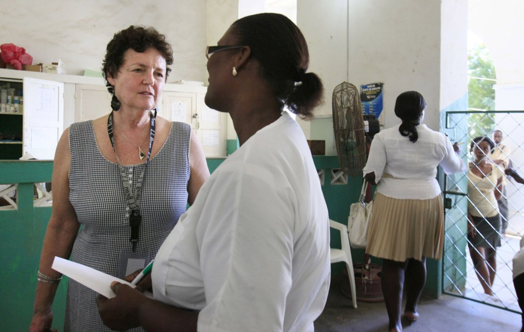 Judy Carl of Portland talks with a nurse at the Justinian Hospital. The Konbit Sante volunteer spent the weekend helping at the hospital, whose emergency room had only a few IV saline units, ibuprofen and acetaminophen.