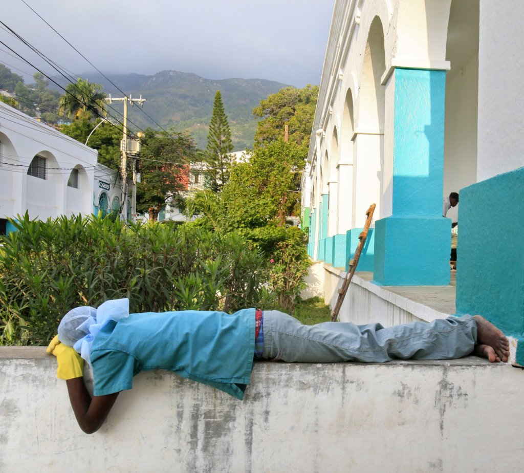A member of the surgical staff at Justinian Hospital sleeps outside the operating unit early Tuesday. A bus with earthquake victims arrived at 1 a.m., and the surgical staff worked on them all night. Konbit Sante funds 26 positions at the hospital.