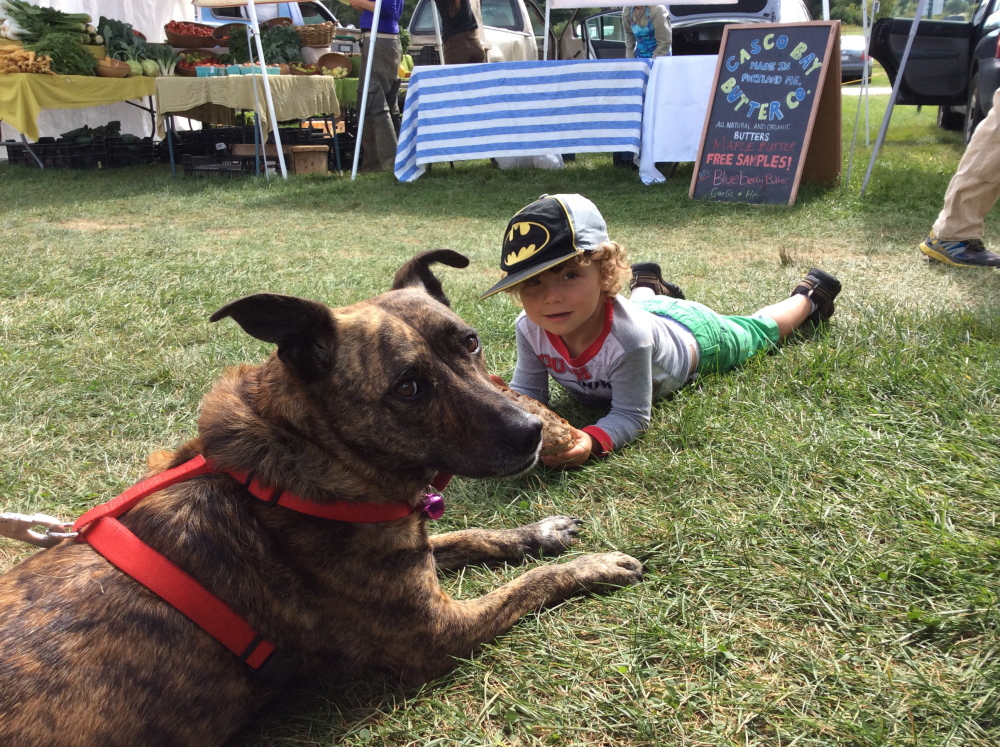 The author’s son, Theo, 3 , with a pal at Crystal Spring Farm market in Brunswick.