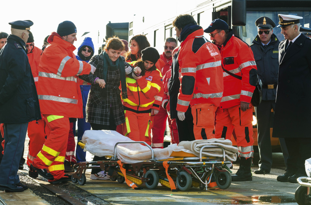 An injured passenger is eased to a stretcher as she and other survivors of the Norman Atlantic ferry fire finally stepped ashore in Taranto, Italy, on Wednesday.