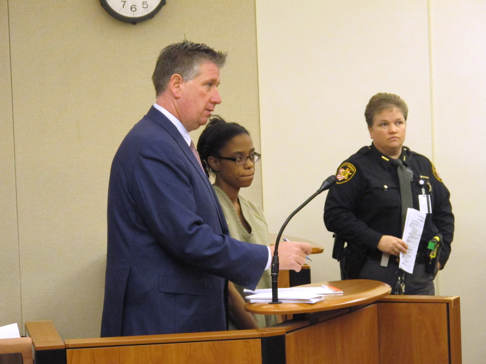 Dainesha Stevens, center, listens during a court appearance where a judge sent a $150,000 bond on endangering children and tampering evidence charges, as her lawyer, Mark Collins, left, answers a question, on Wednesday, Dec. 31, 2014, in Columbus, Ohio. The charges are related to the disappearance of Stevens’ 14-month-old son, Cameron Beckford, whose body was found in a creek Wednesday. (AP Photo/Andrew Welsh-Huggins)