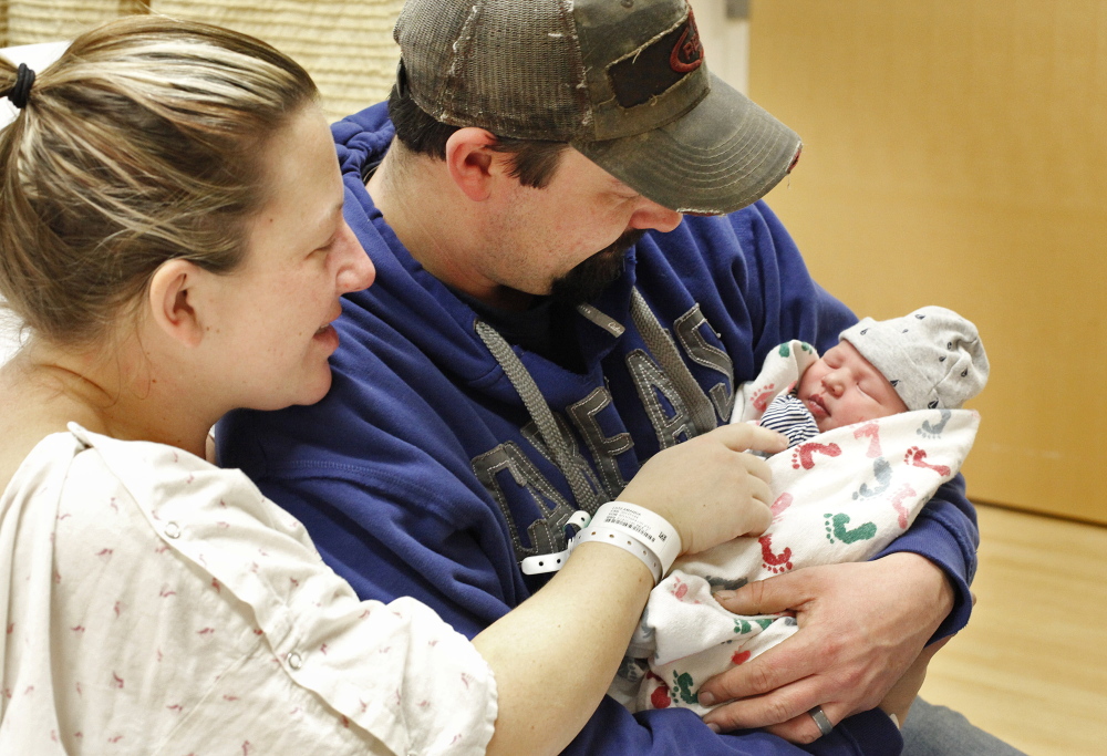 Amanda and Travis Lutz of Lyman admire their newborn son, Owen Marshall Lutz.