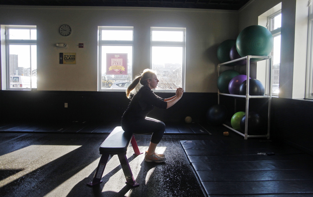 Rachel Fisk of Portland does squats while working out at Planet Fitness in Portland on Thursday. "I’ve been struggling lately with fitting it into my schedule and getting motivated,” she said.