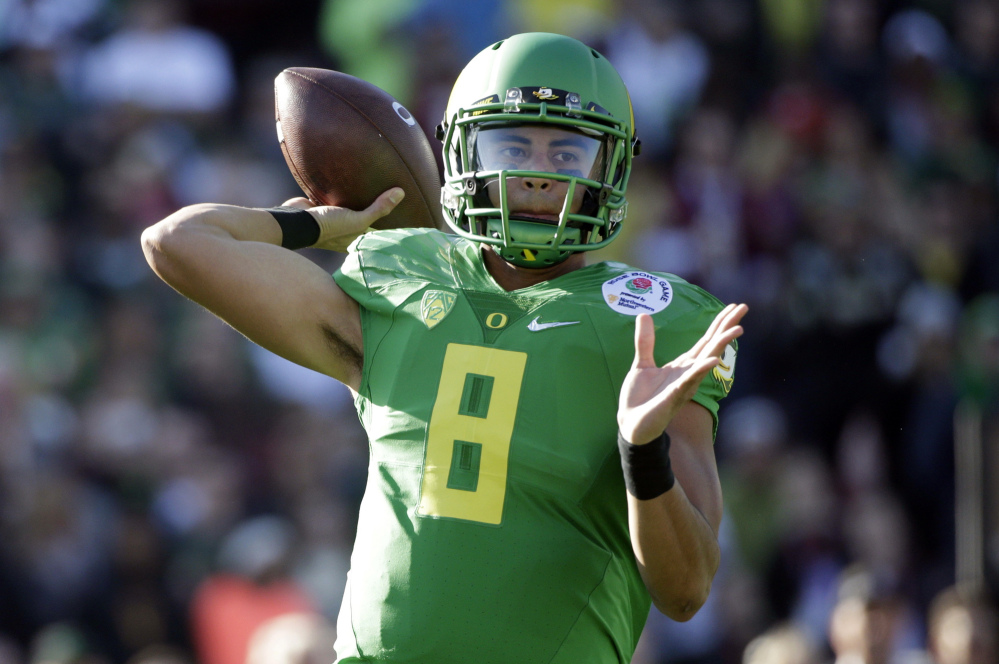 Oregon quarterback Marcus Mariota prepares to throw against Florida State during the first half of the Rose Bowl NCAA college football playoff semifinal Thursday in Pasadena, Calif. The Associated Press