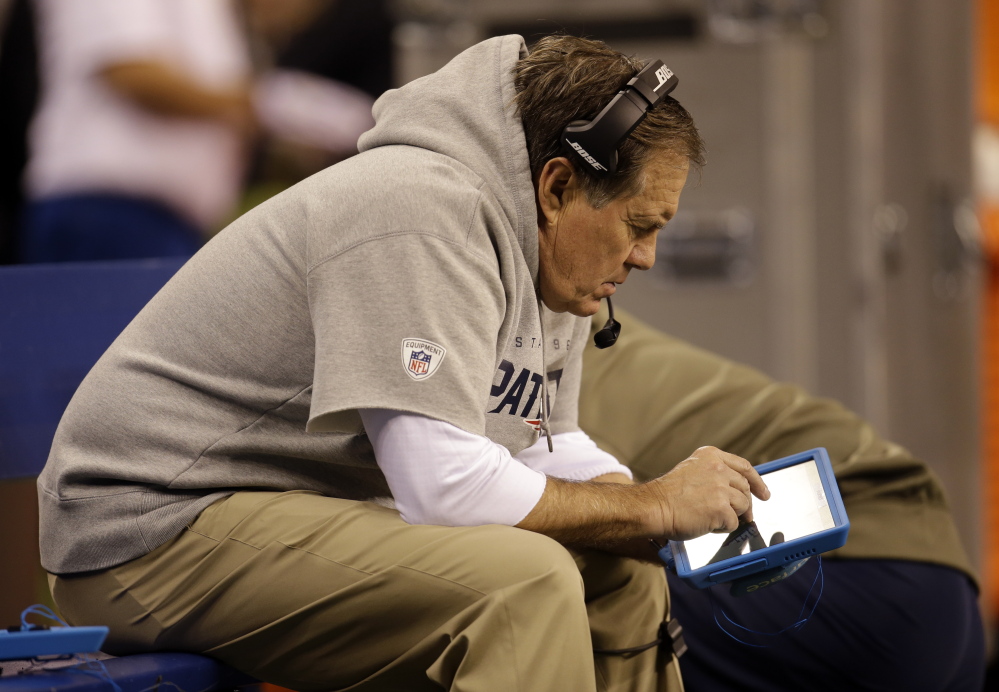 The NFL authorized the use of tablets on the sidelines this season, and New England Coach Bill Belichick takes full advantage during a Nov. 16 game at Indianapolis. Advances in technology have changed scouting – where once it took days to get scouts’ game notes, now film is ready in hours.