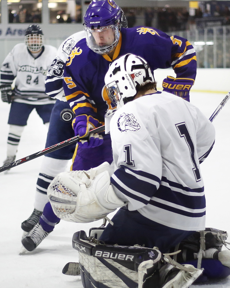 Portland/Deering goalie Alex Girsch makes a point-blank save on Chris Vallee of Cheverus in Thursday’s City Cup game at the Troubh Ice Arena in Portland. Vallee scored two goals as the Stags defended their City Cup title with a 7-0 win over Portland/Deering.