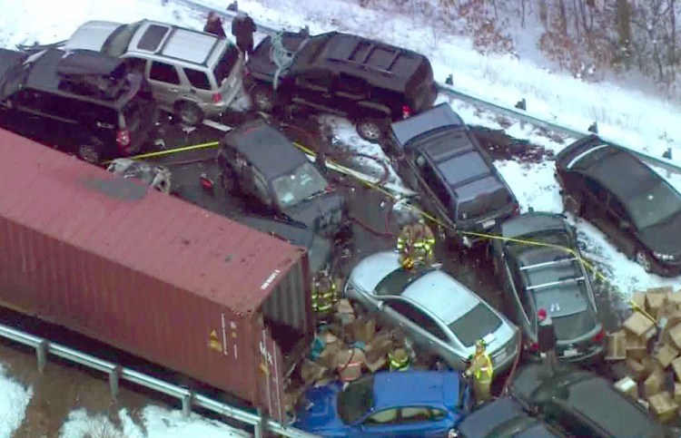 Emergency personnel work the scene along Interstate 93 near Ashland, N.H., where at least 35 vehicles were involved in two pileups after some fast-moving snow squalls Friday, in this frame grab made from aerial video.