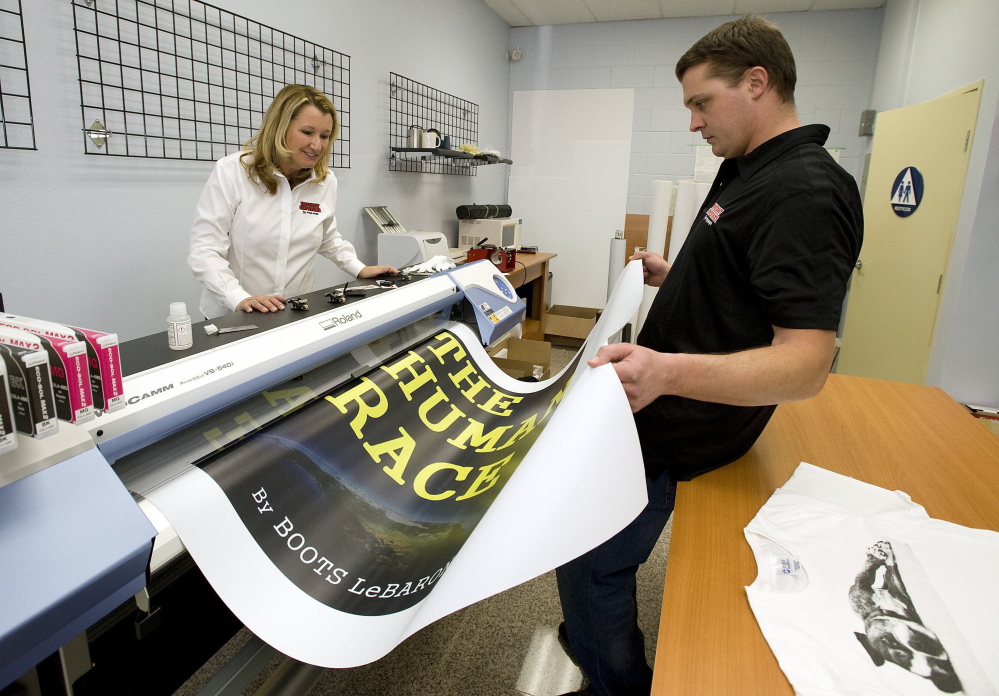 Kathy Schneider and son, Steve Schneider, print a banner at Instant Imprints in Fullerton, Calif. People like Kathy Schneider, 57, who started her own business after being downsized from a job in insurance, are helping to make Americans ages 55 to 64 the largest growing age group of entrepreneurs in the U.S.