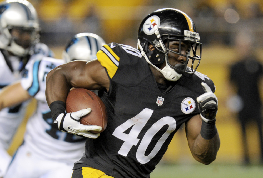 Pittsburgh Steelers running back Josh Harris runs away from Carolina Panthers defensive back Colin Jones in a preseason game in Pittsburgh in August. Harris is among the lesser-known players who could step up this wild-card weekend.