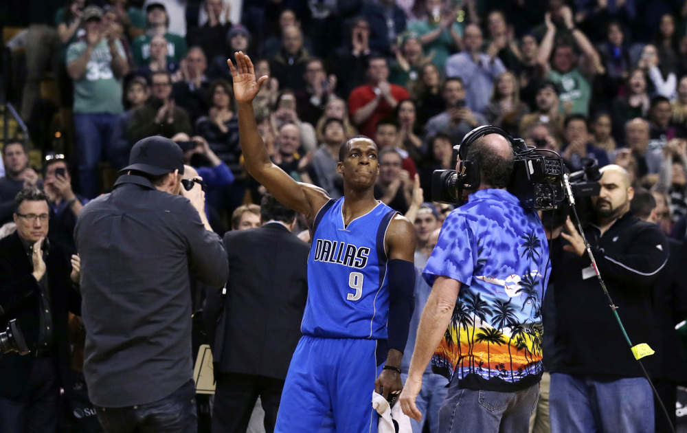 Dallas Mavericks guard Rajon Rondo waves to fans and photographers after a video presentation of his career with the Boston Celtics, during a break between the first and second quarters of Friday night’s game in Boston. Rondo scored 29 points in his first game at the TD Garden since he was traded to Dallas last month.