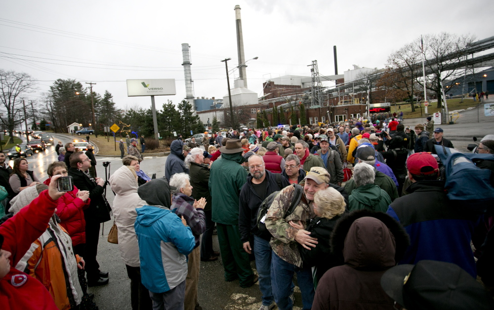 Hundreds of community members greet workers at Verso Paper’s Bucksport mill after their final shift on Dec. 17. A union representing millworkers has sued, claiming that the mill is being sold because Verso wants to limit competition as it merges with its biggest rival.
