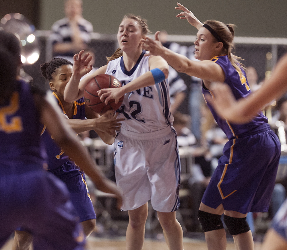 Sigi Koizar of Maine attempts to control the ball while fending off pressure from Margarita Rosario, left, and Sarah Royals of Albany in the second half of Albany’s 49-43 victory at the Cross Insurance Center.