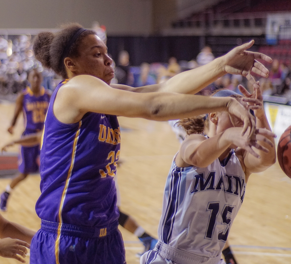 Tiana-Jo Carter, left, who led Lake Region to the Class B state championship last season, scrambles for a loose ball Saturday with Lauren Bodine of Maine. In her freshman year, Carter is averaing 7.6 points and 6.6 rebounds for Albany, with 10 blocks and 11 steals.