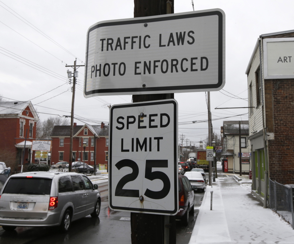 A sign advises motorists that they may be monitored by traffic cameras in Elmwood Place, Ohio, even after the cameras were removed by a Hamilton County judge’s ruling.