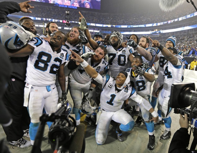 Carolina Panthers players celebrate in the final moments of Saturday's wild card playoff game against the Arizona Cardinals in Charlotte, N.C. The Panthers won 27-16.