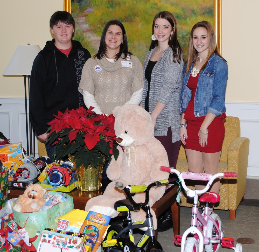 The Biddeford Regional Center of Technology’s Student Leadership Council and Biddeford High School’s Interact Club donated toys for children at Southern Maine Health Care during Christmas. Karen Chasse, second from left,  Southern Maine Health Care’s development manager, accepts toys from Jordan Stickles, left, and Madison Lawlor, co-presidents of the council and and Sami Pinard, right, vice president.