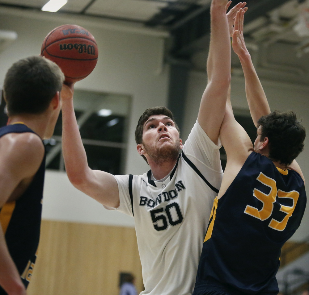 Bowdoin’s John Swords wards off USM’s Ben Jackson while taking a shot Sunday. Swords had 19 points and 12 rebounds in a 76-61 win.