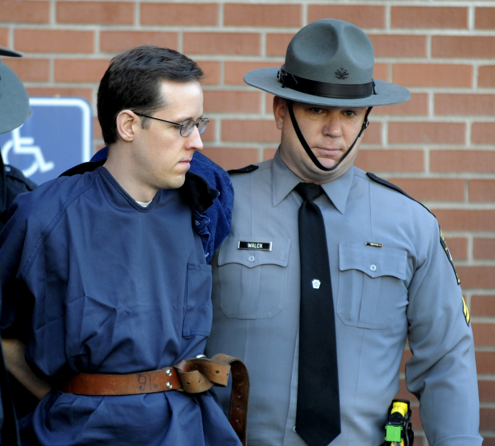 Eric Frein is led from the courthouse after his hearing Monday in Milford, Pa. Frein is charged with fatally shooting one state trooper and wounding another.