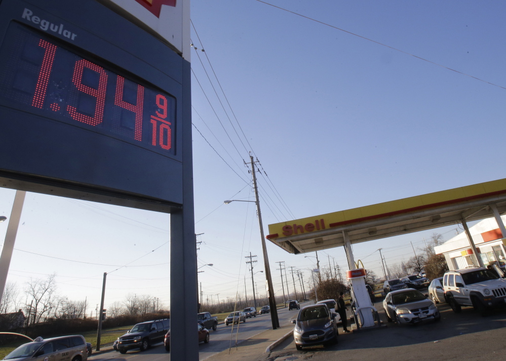 A gas station in Cleveland advertises a price of $1.94 per gallon. The price of oil plunged Monday and dipped below $50 a barrel for the first time in more than five years.