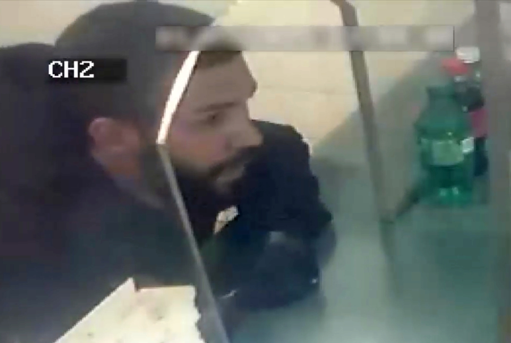 In this photo from a surveillance video provided by the New York Police Department, an alleged suspect orders food at a Chinese restaurant in the Bronx borough of New York, Monday.