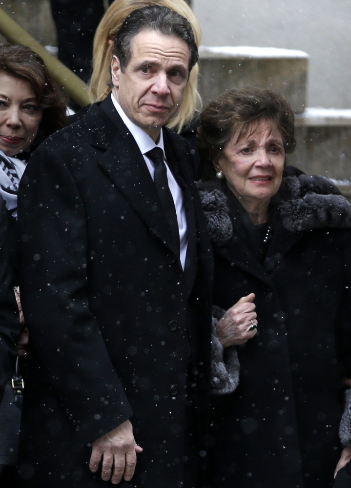New York Gov. Andrew Cuomo and his mother, Matilda, watch as the body of Mario Cuomo is loaded into a hearse at his funeral in New York on Tuesday.
