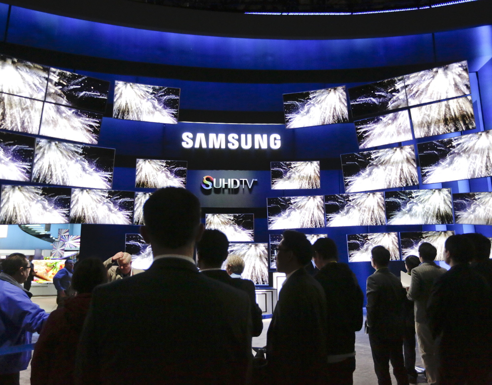 The Samsung booth draws a crowd Tuesday at the gadget show in Las Vegas. Some of the company's new sets make colors purer and the screen brighter.