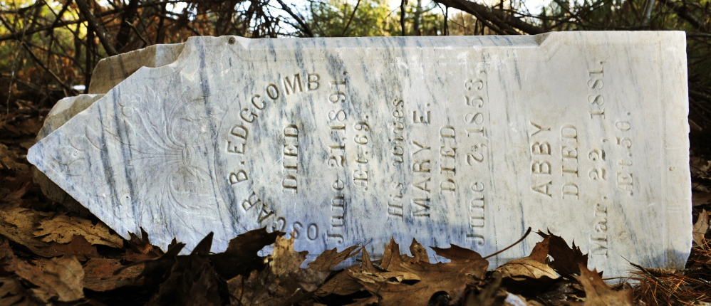 This obelisk grave marker with names on all four sides sits toppled at the bottom of the hill at Edgecomb cemetery in Gardiner.