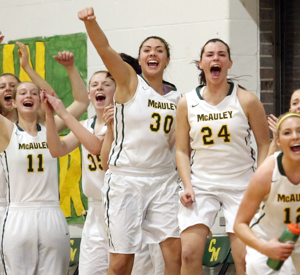 Kaeli Leddy, 30, and Amanda Spink, 24, lead the cheers after a late basket helped once-beaten McAuley send Thornton Academy to its first loss.