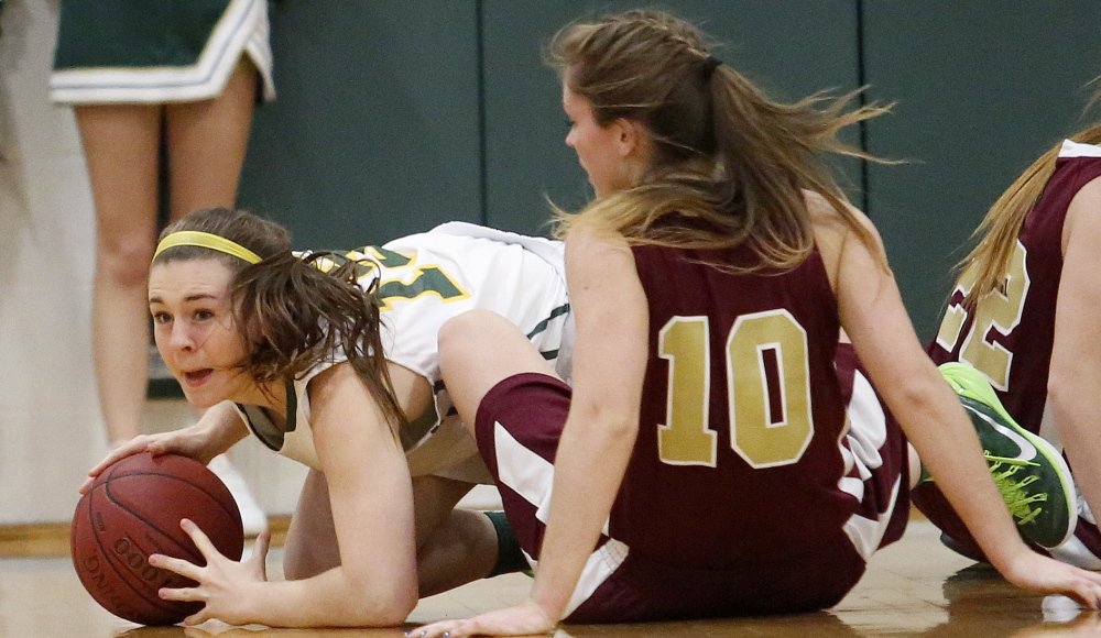 It was that kind of physical game between the top two girls’ basketball teams in Western Class A. Brooke Howard of McAuley looks to pass from the ground in front of Kaitlyn McCrum of Thornton Academy, also on the ground, during McAuley’s 29-25 victory Tuesday night.