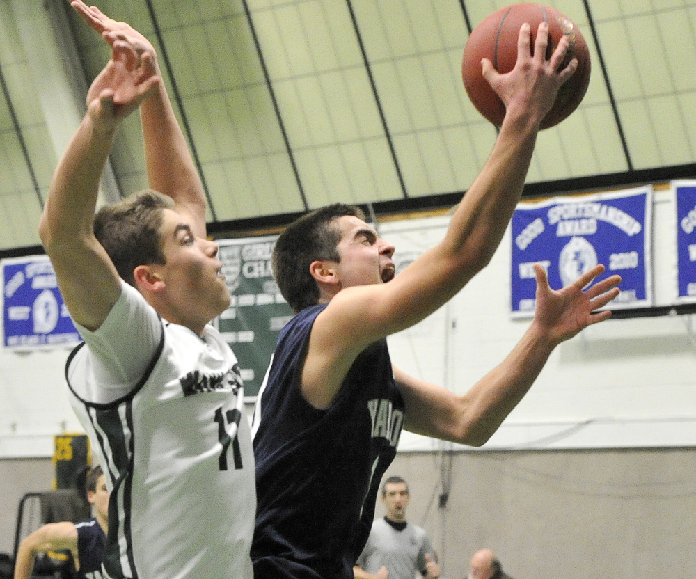 Cody Clark of Yarmouth slips past Milo Belleau of Waynflete for a layup Tuesday during the game between unbeaten Western Maine Conference teams. Belleau scored 17 points to lead the Flyers to a 53-43 victory.