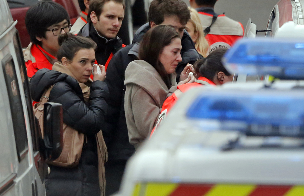 People are evacuated outside the French satirical newspaper Charlie Hebdo’s office, in Paris, Wednesday.