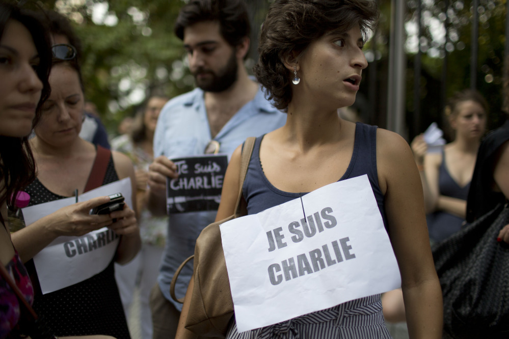 People in Buenos Aires, Argentina, stand outside France’s embassy wearing signs that read in French “I am Charlie,” in solidarity with those killed in Wednesday’s attack at the Paris offices of the weekly newspaper Charlie Hebdo.