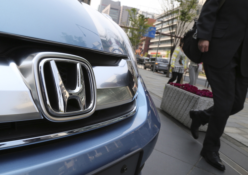 Honda Motor Co. displays a vehicle at its headquarters in Tokyo. U.S. officials say the automaker has agreed to pay a $70 million fine for failure to report violations.