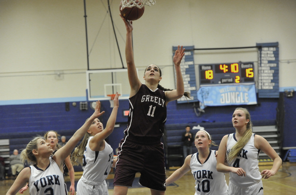 Greely’s Ashley Storey goes for a layup as, from left, York’s Paige McElwain, Madigan Cogger, Mia Briggs and Shannon Todd look on during Thursday’s game at York. The hosts won 48-43.