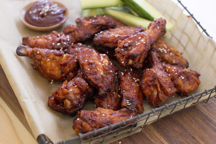 Korean-style chicken wings are made with gochujang, which in Korean cooking is used as a base for stews and marinades, as well as a feisty condiment for one-pot dishes such as bibimbap. (AP Photo/Matthew Mead)