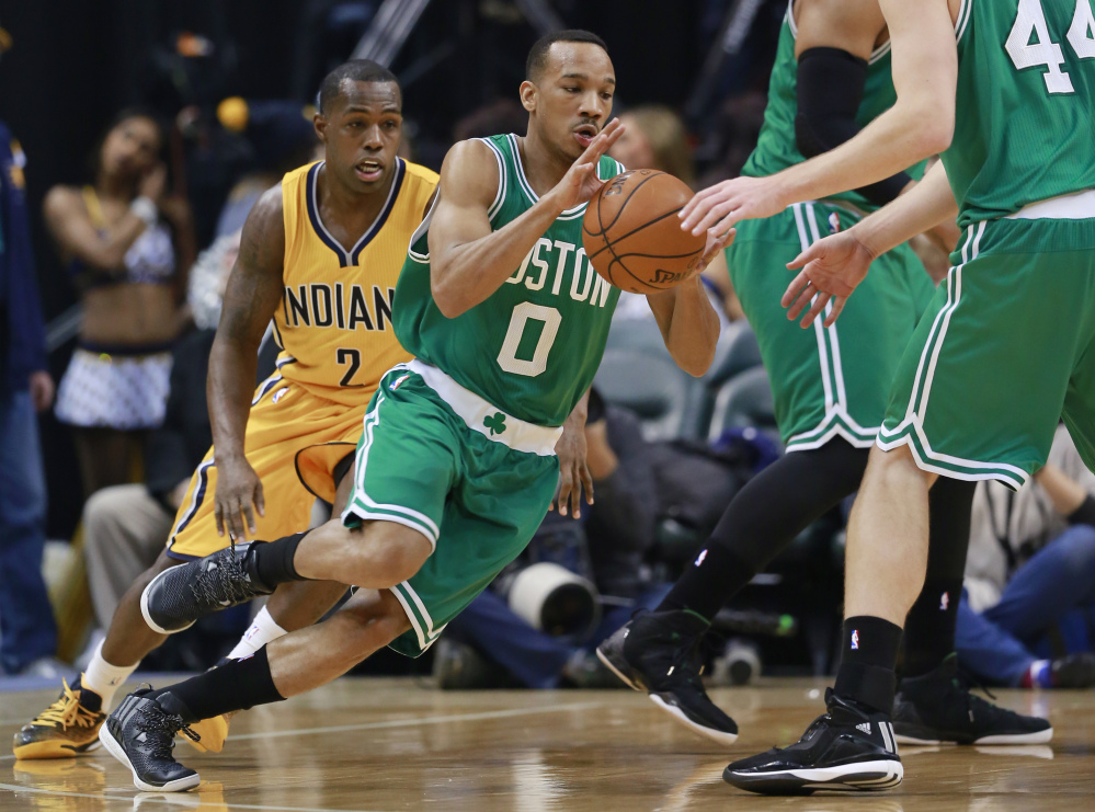 Boston Celtics guard Avery Bradley receives the ball from center Tyler Zeller while Indiana guard Rodney Stuckey, left, pursues Bradley during the first half of Friday's game in Indianapolis.