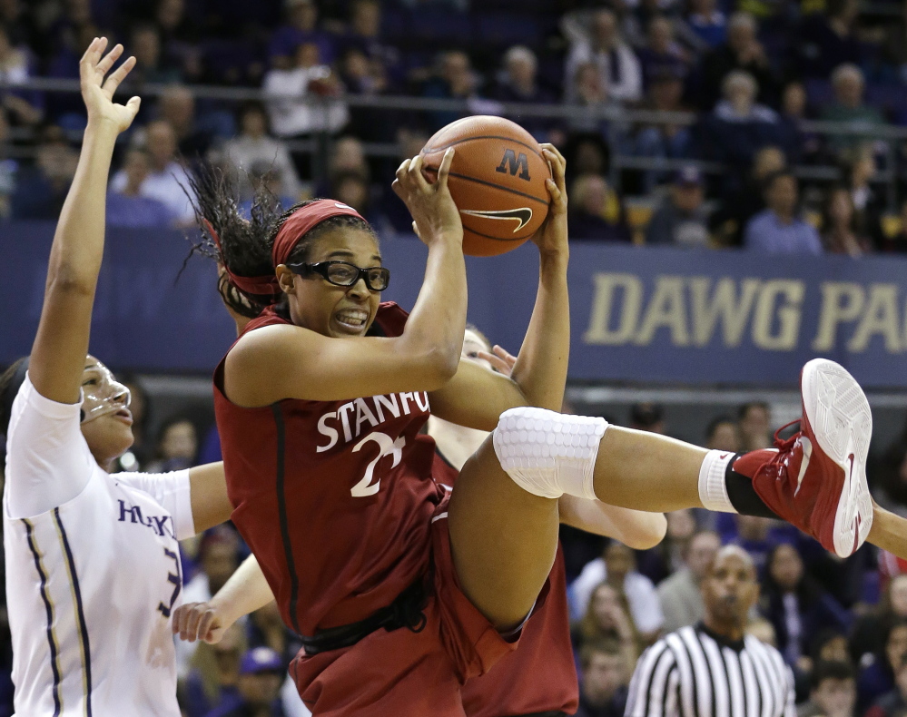 Erica McCall of Stanford grabs a rebound in front of Washington’s Talia Walton during their game Friday night in Seattle.