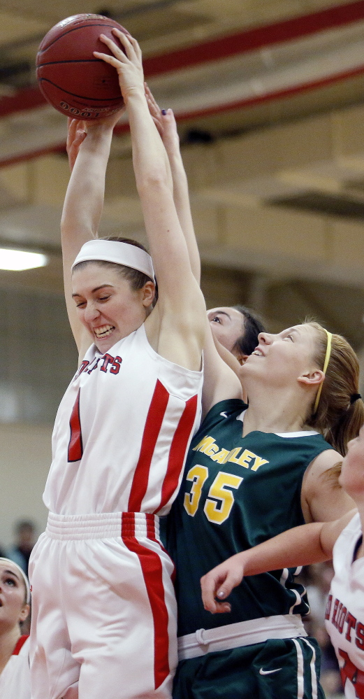 Paige Carter of South Portland controls the inside to haul down a rebound in front of Emily Weisser of McAuley. Despite the loss, the Red Riots held a 33-19 advantage on the boards.