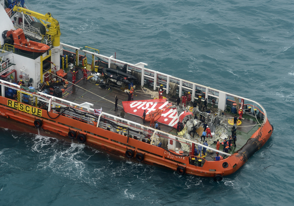 A portion of the tail of AirAsia Flight 8501 is seen on the deck of a rescue ship after it was recovered from the sea floor on the Java Sea, on Saturday.